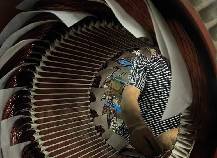 Technician working inside a motor stator